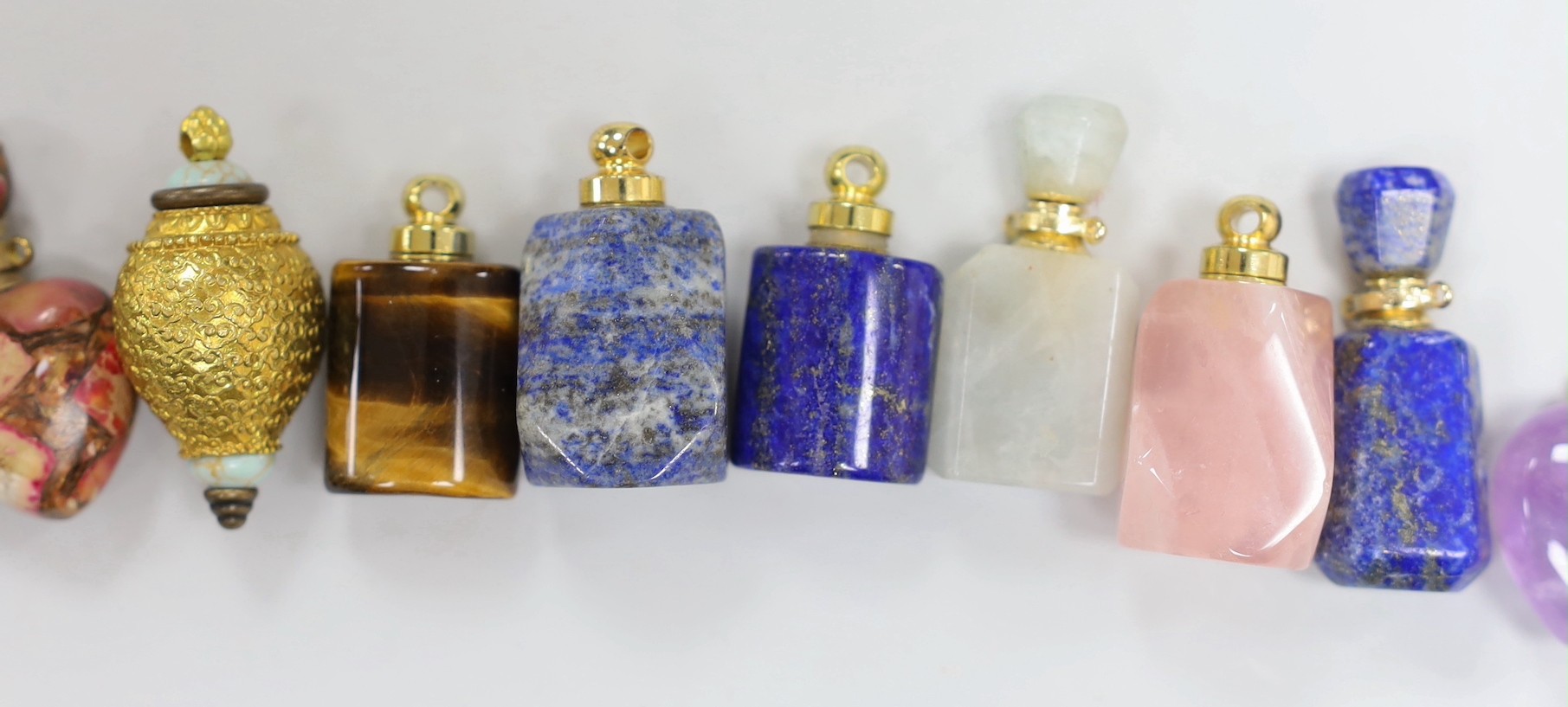 Eleven assorted gilt metal mounted hardstone and semi-precious stone small scent bottles, including Tiger's eye, rose quartz, lapis lazuli and amethyst.